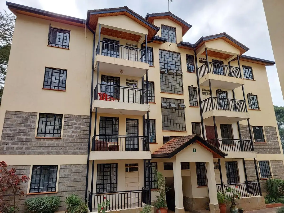 Multi-story residential building facade with balconies and pitched roofs