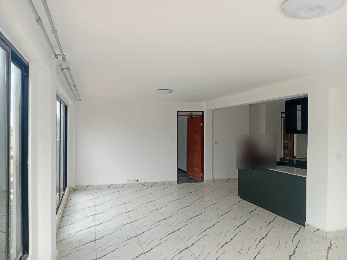 Open-plan living space with kitchen counter visible on right