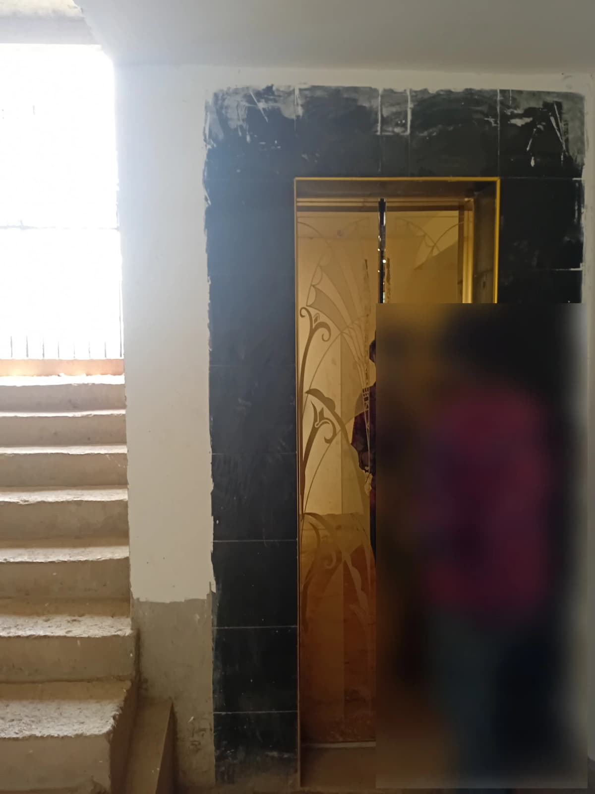 Building corridor with wooden door and staircase access