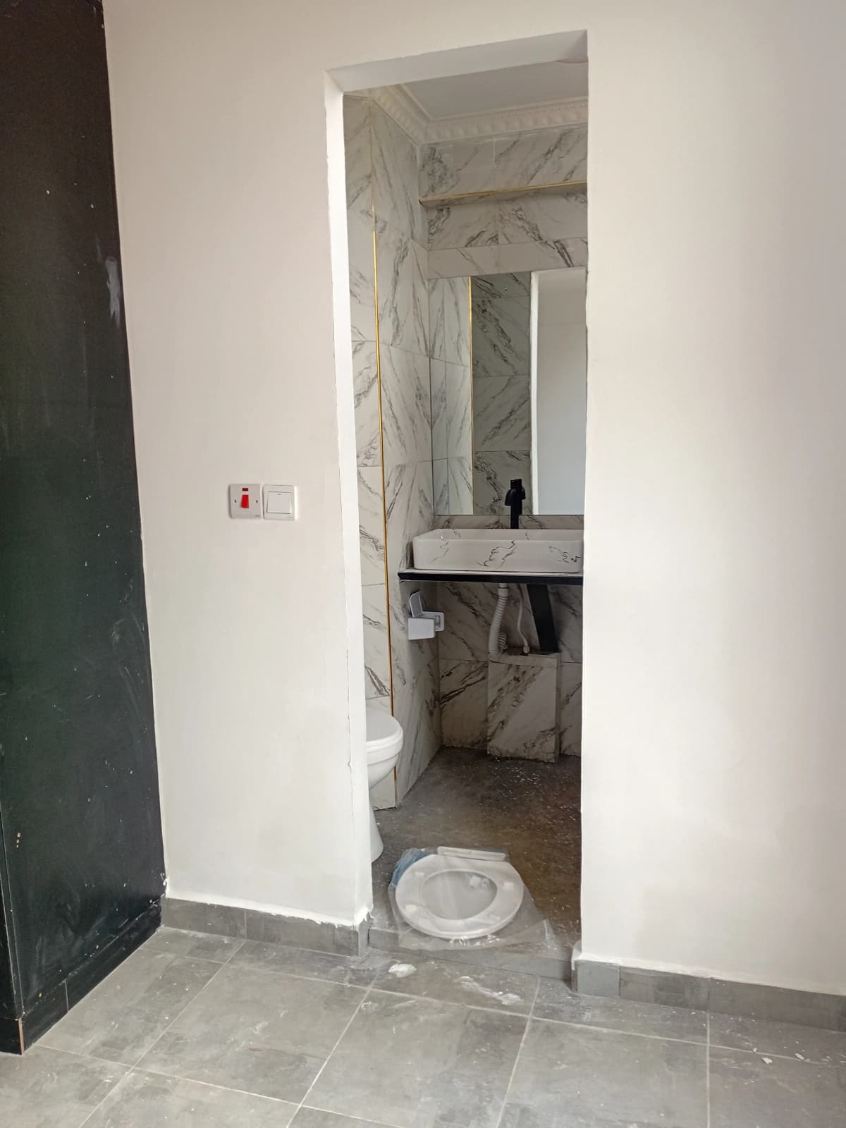 Modern bathroom with marble-effect tiles and vanity sink