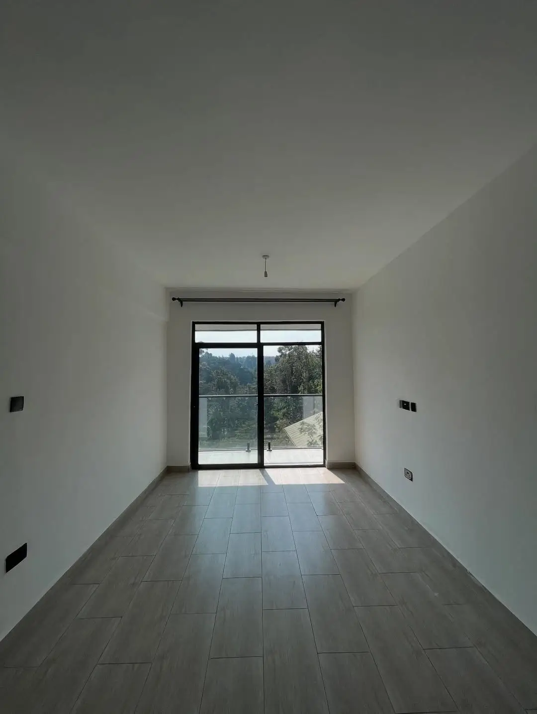 Interior space with sliding glass doors overlooking landscape
