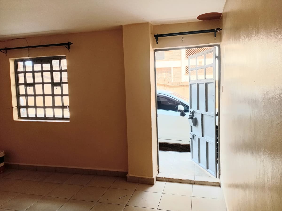 Entrance lobby with tiled floor and security gate