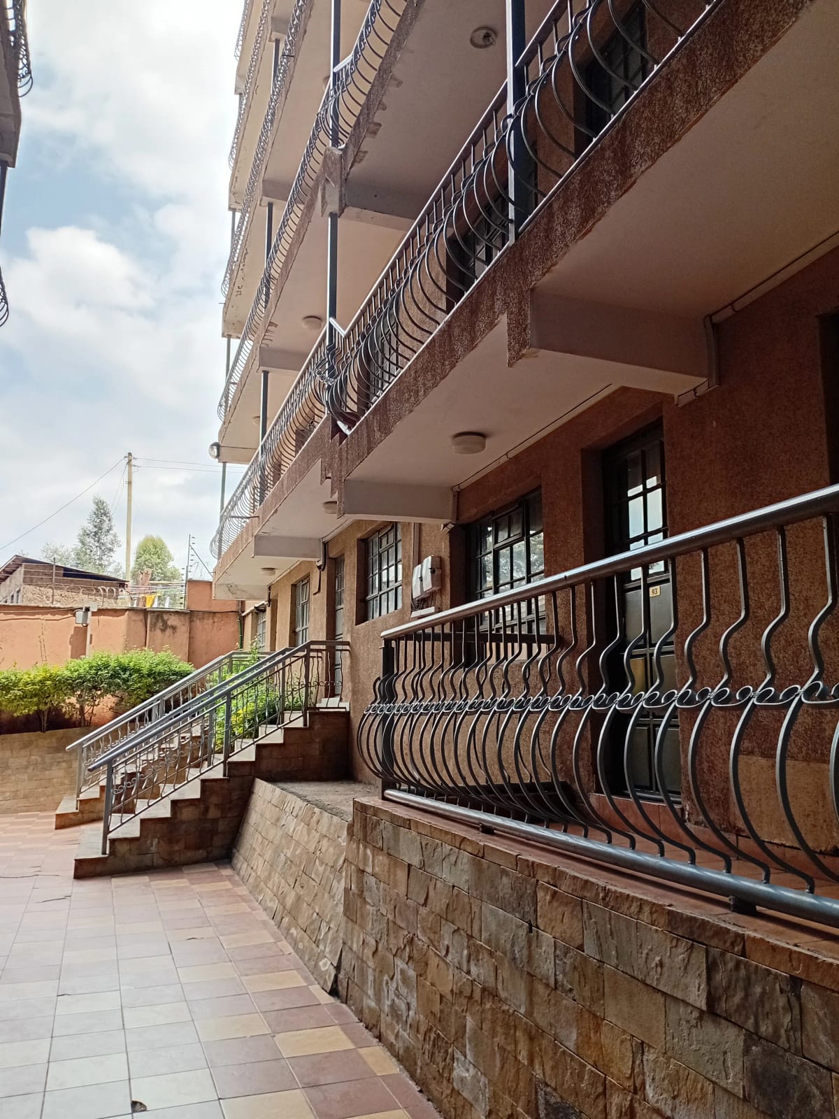 Multi-story residential building facade with balconies and walkway
