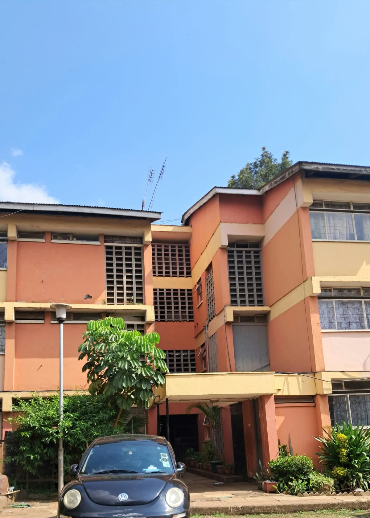Multi-story residential building facade with orange-painted walls
