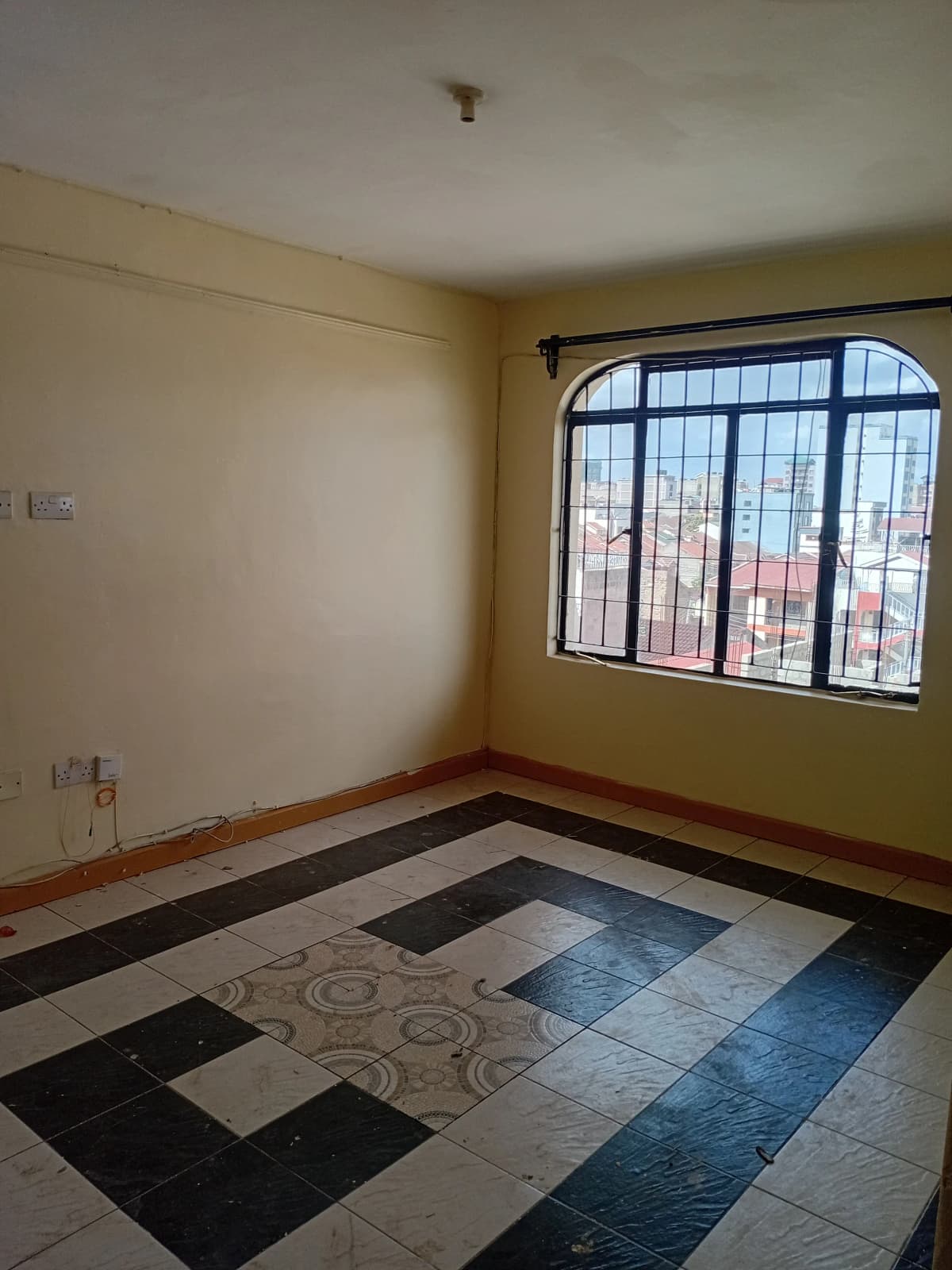 Spacious living room with geometric tile flooring and large windows