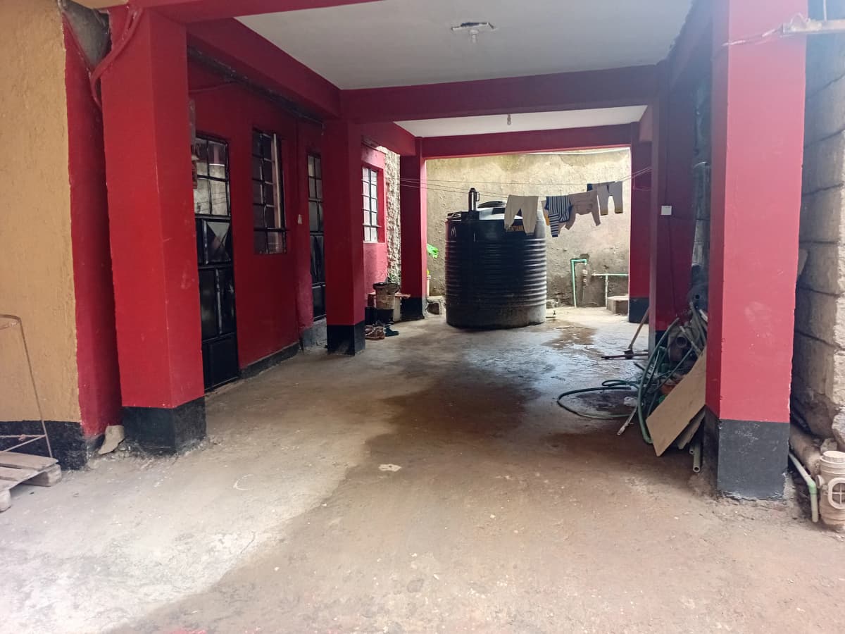 Red-painted garage or utility space under construction or renovation