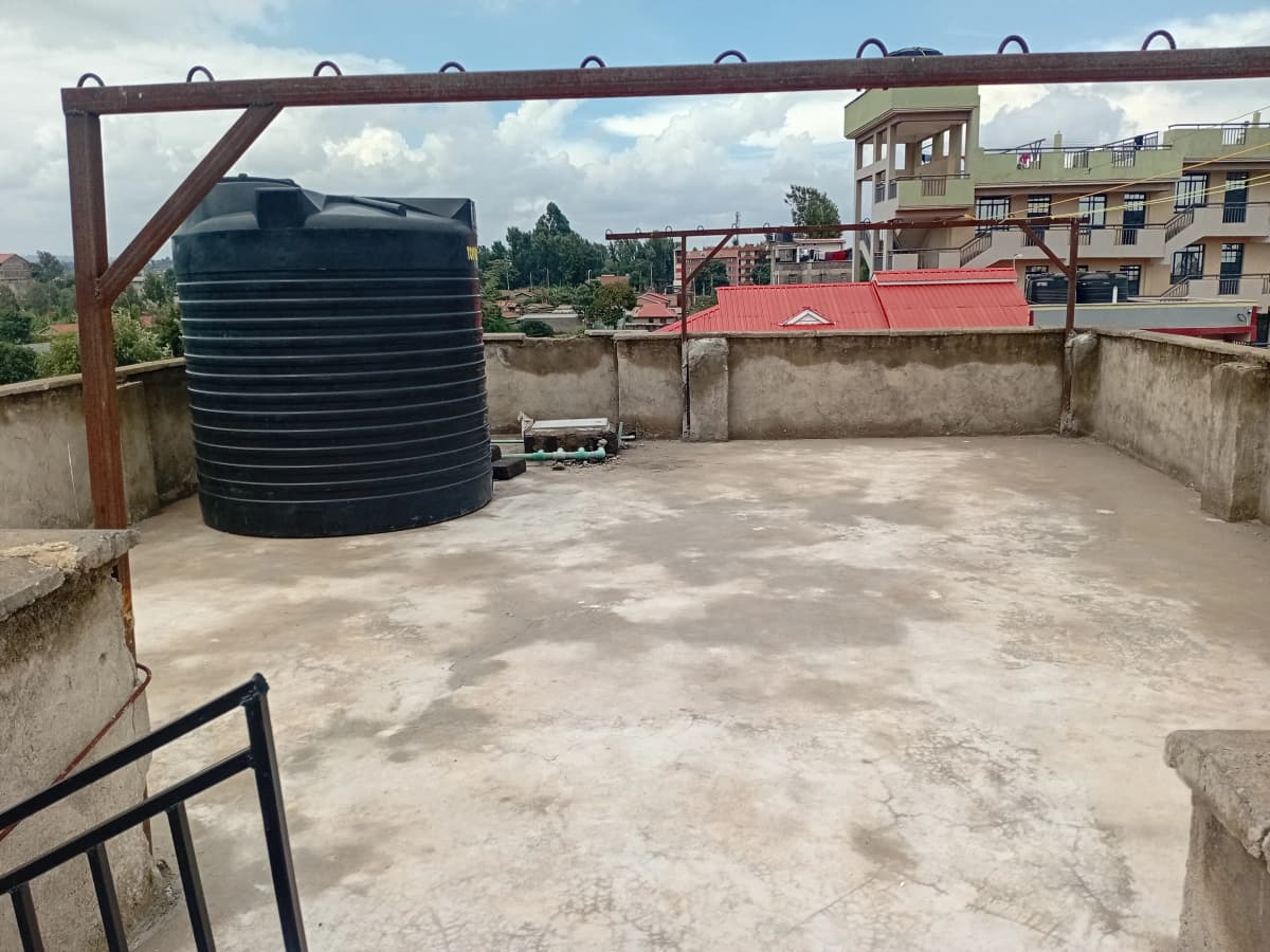 Rooftop compound with water tank and metal framework structure