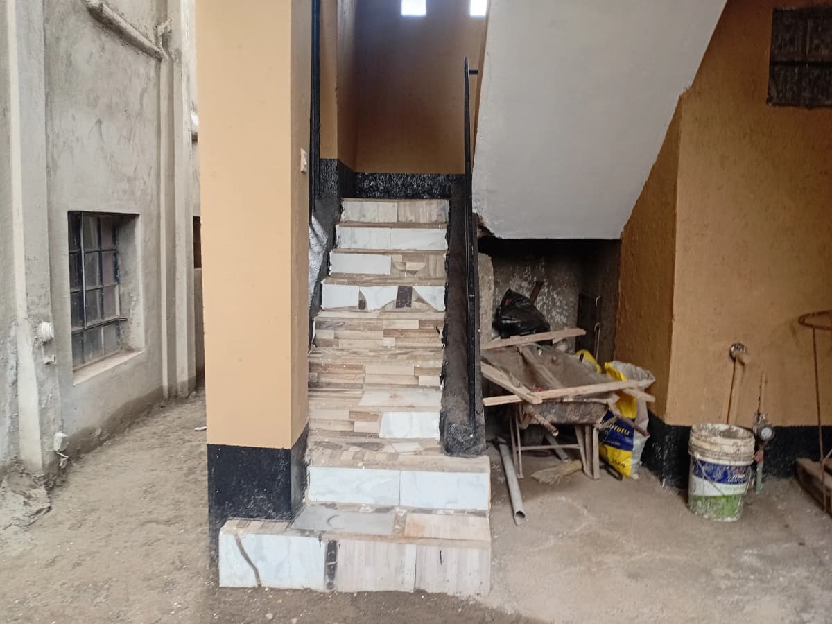 Interior space under construction with stairs and building materials