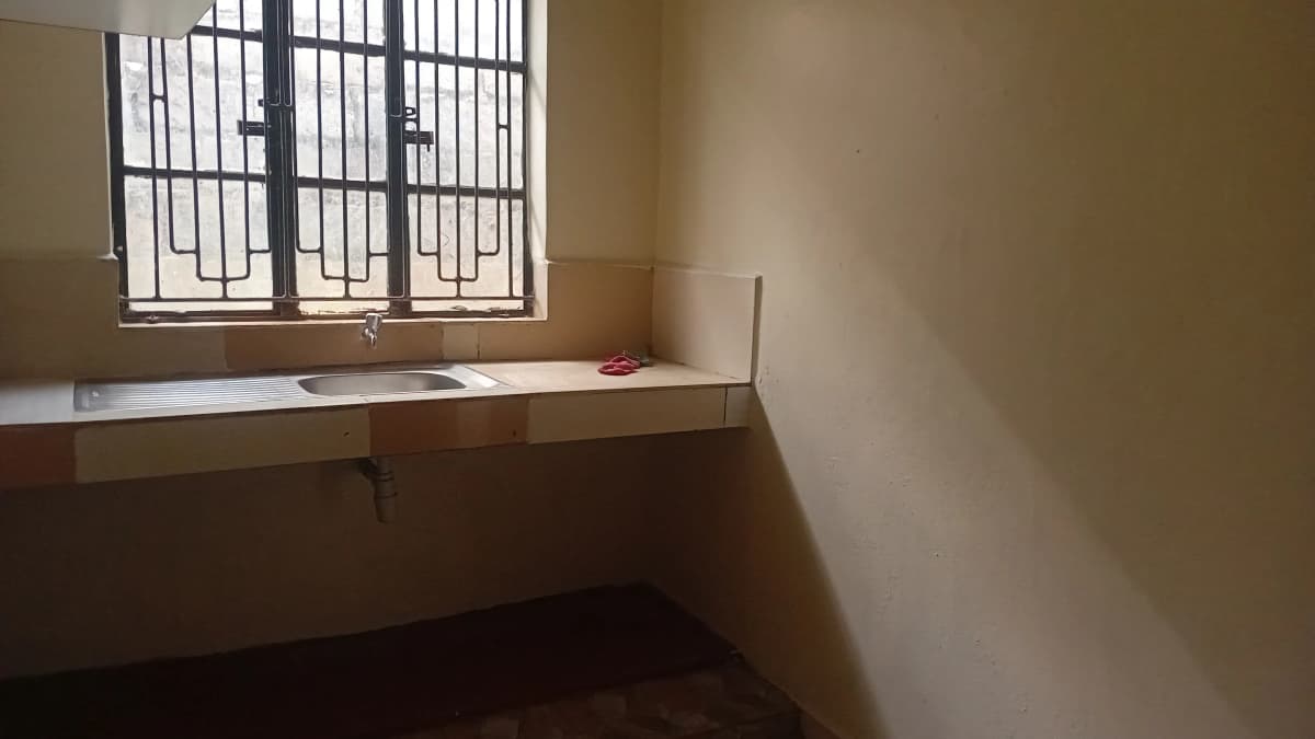 Utility room with built-in counter and barred window