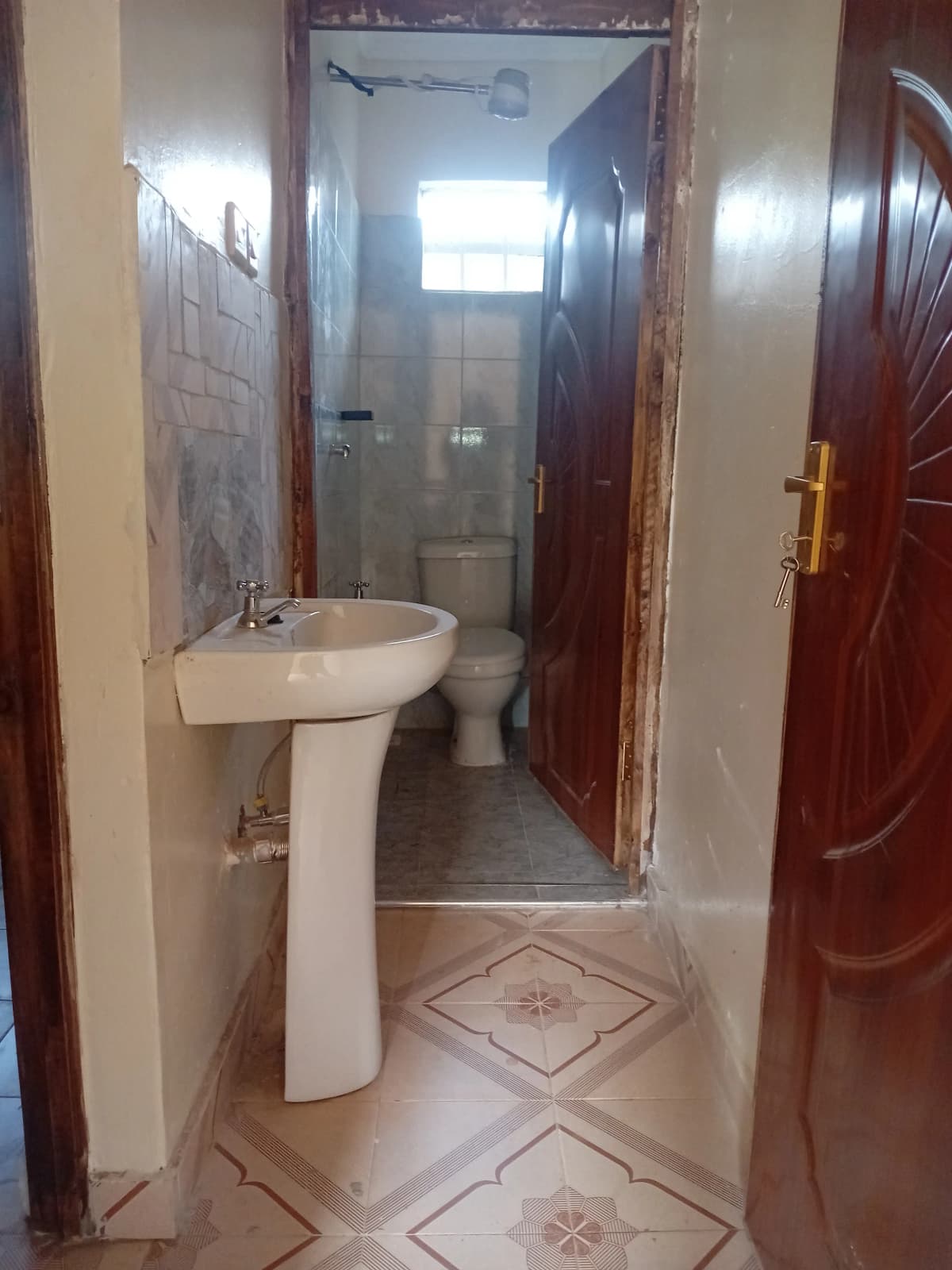 Bathroom with pedestal sink, toilet, and shower enclosure
