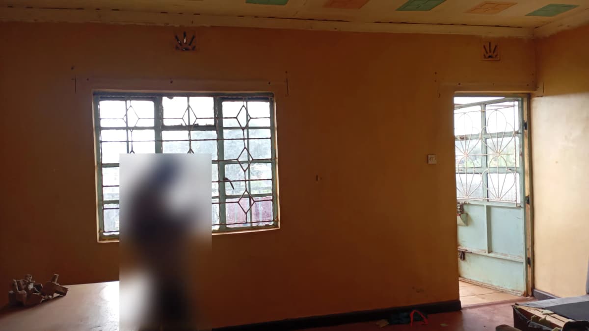 Spacious room with large windows and warm ochre walls