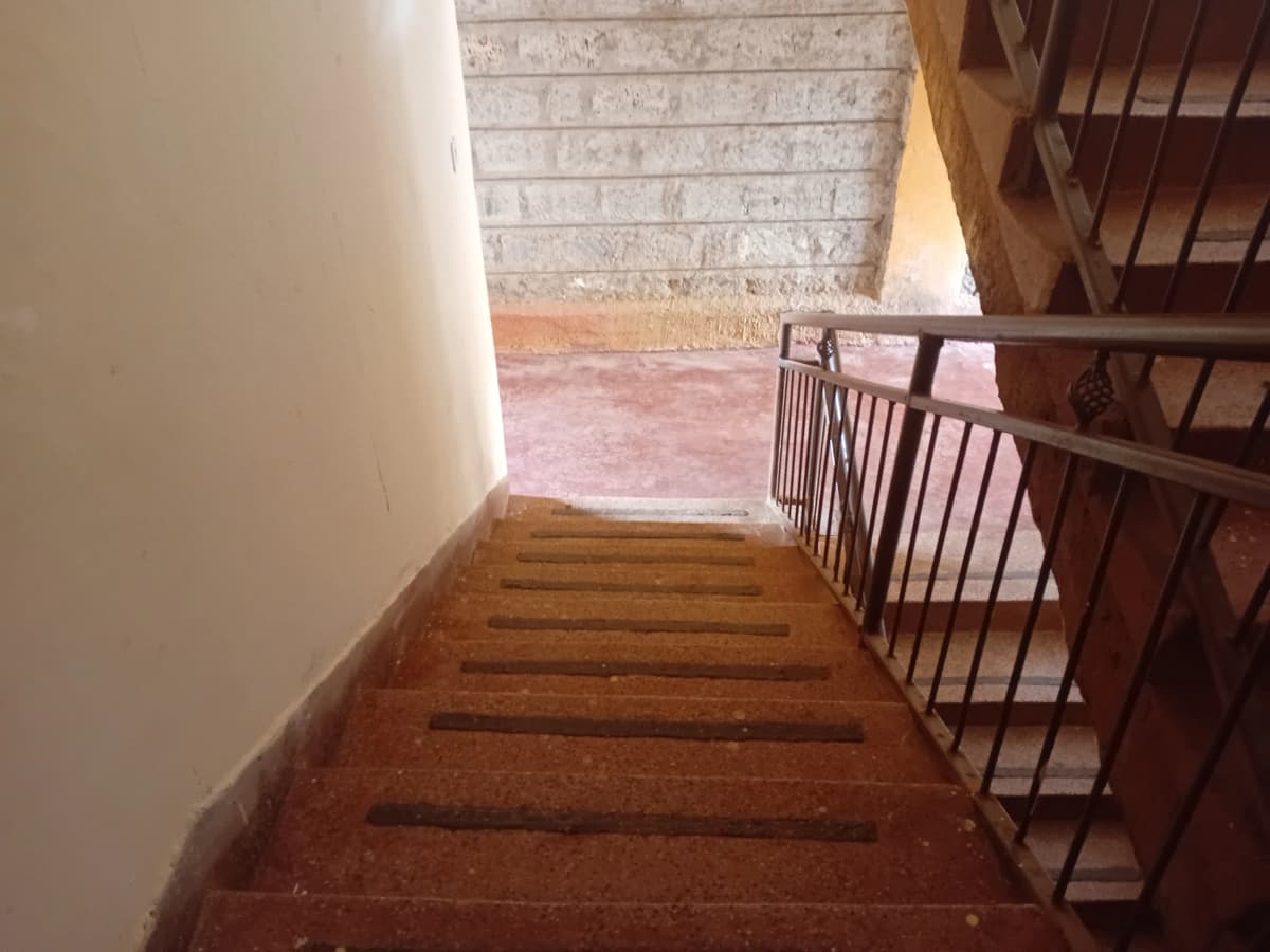 Interior stairwell with wooden steps and metal railing