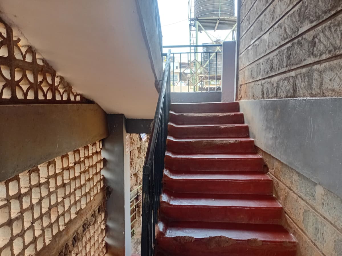 Interior stairwell with red carpet leading upward