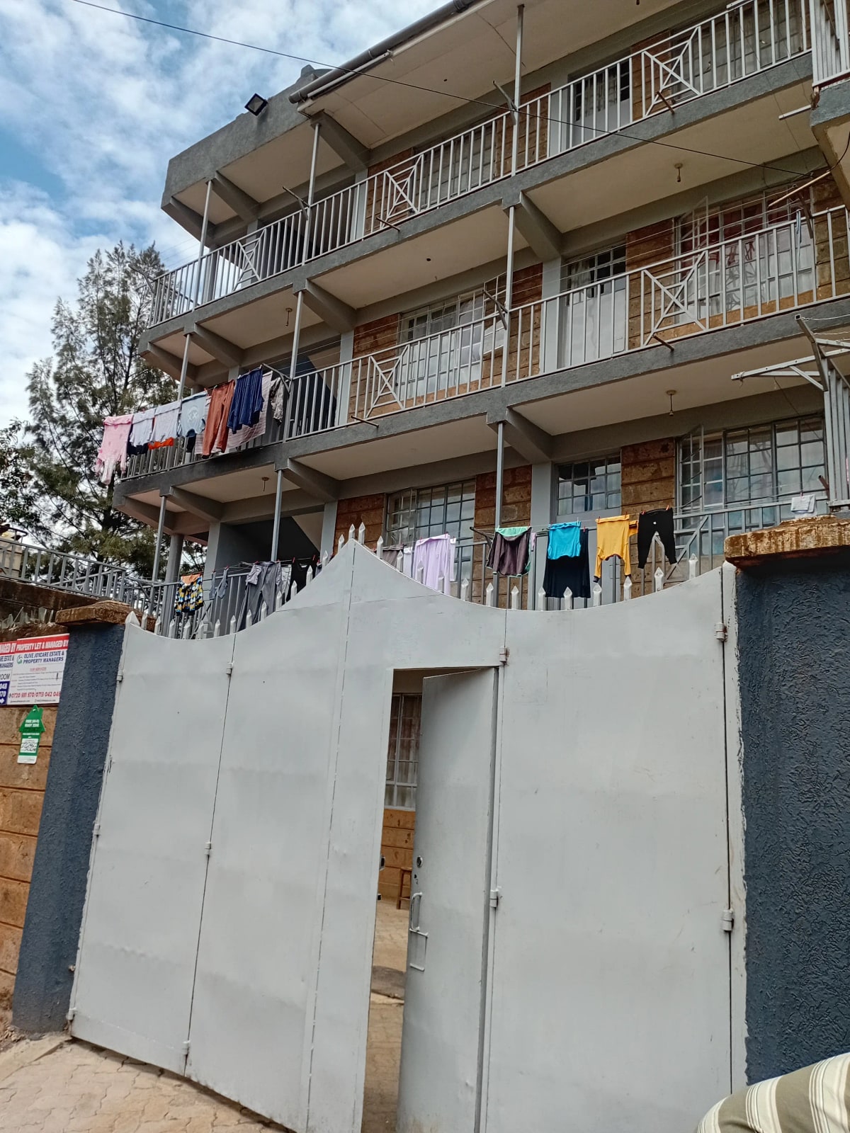 Multi-story residential building facade with balconies and laundry