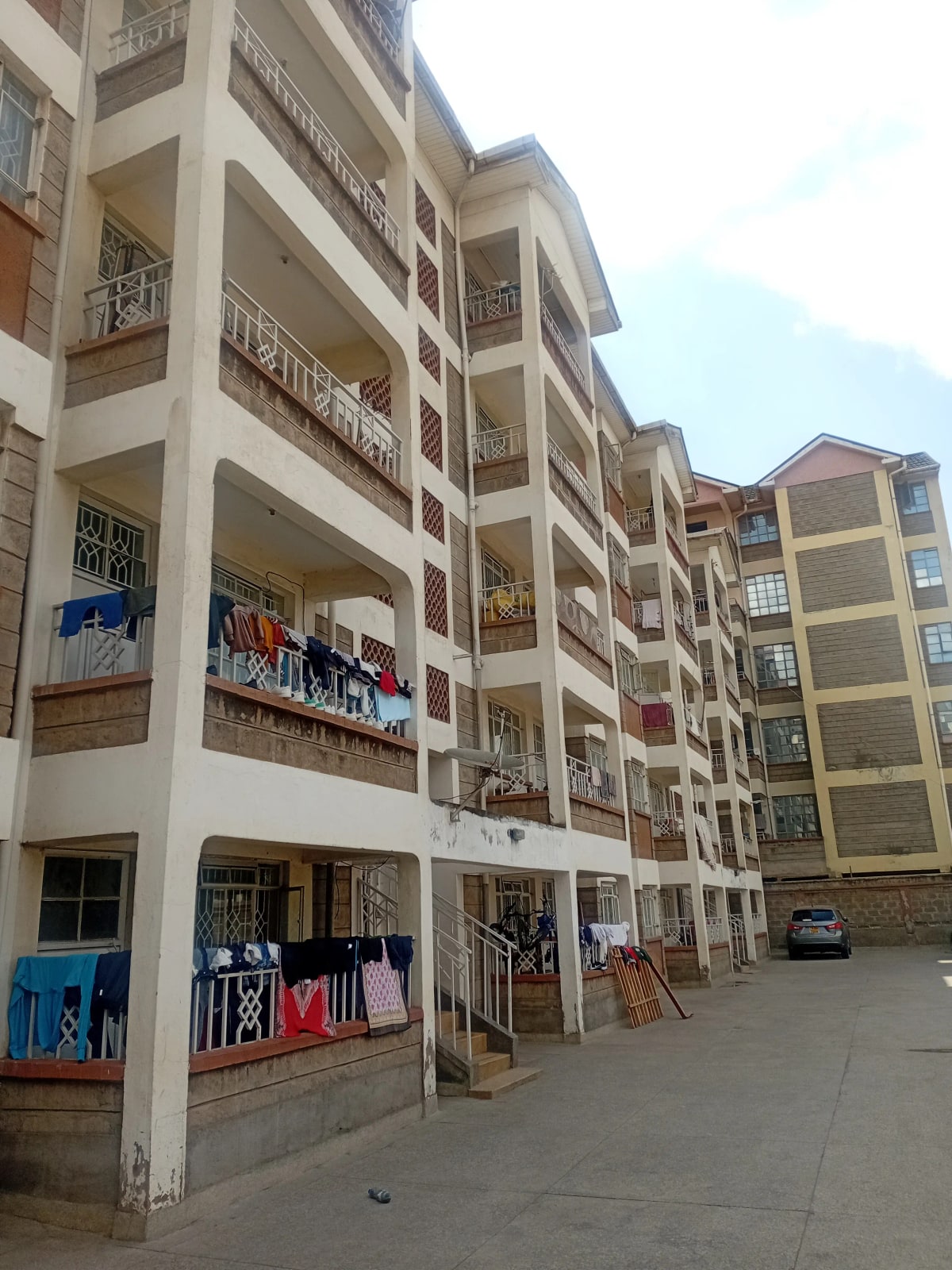 Multi-story residential building facade with ground-level shops