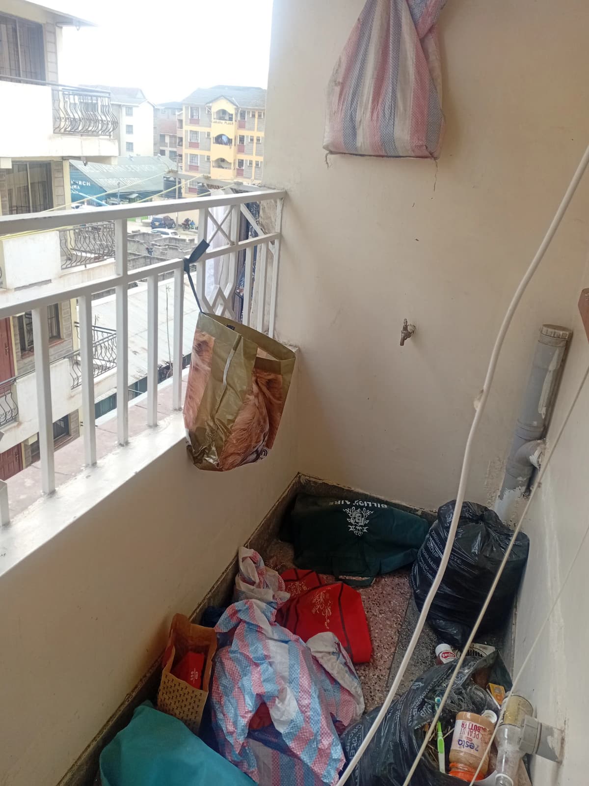 Compact balcony with metal railings and city view