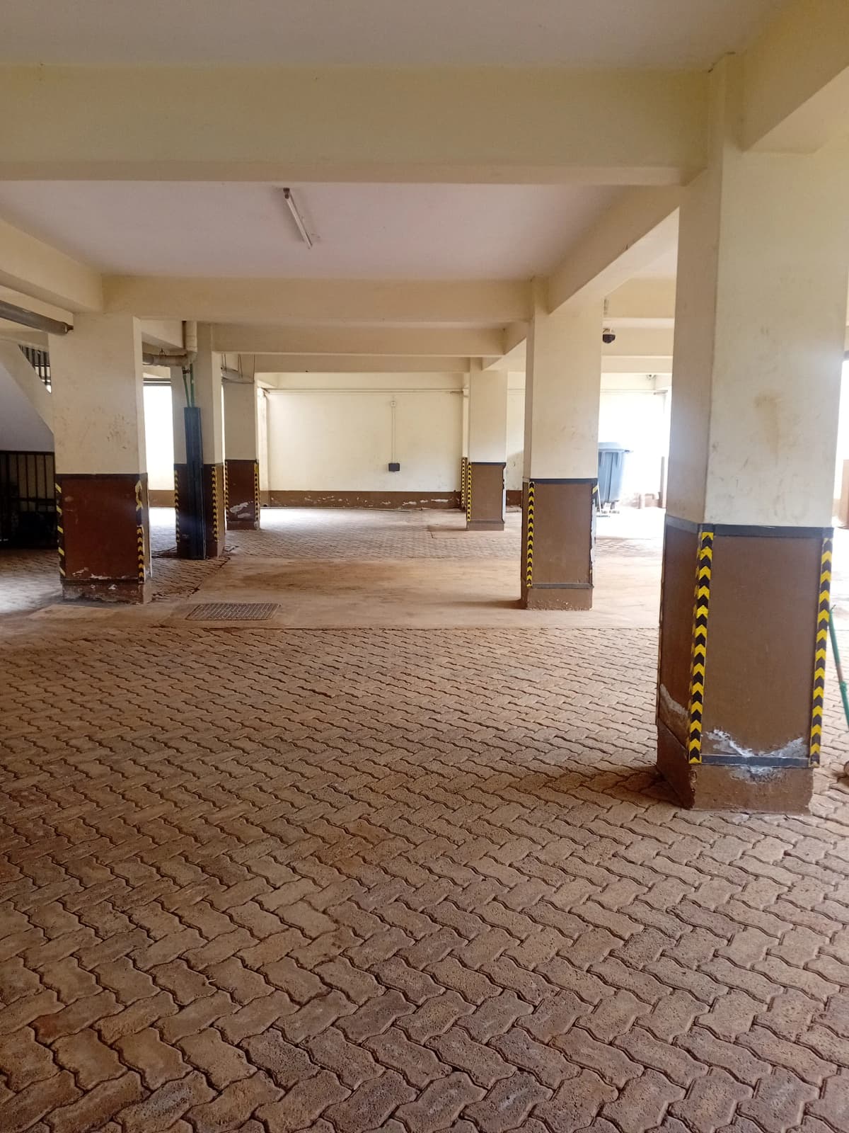 Covered multi-level parking structure with brick pavement
