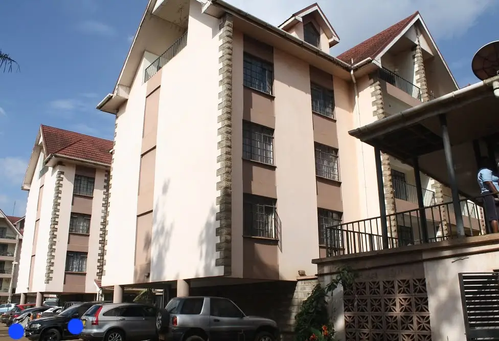 Multi-story residential building facade with parking below