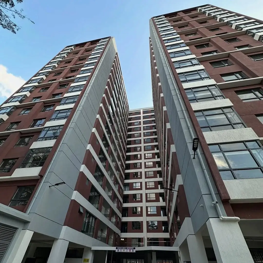 Modern multi-story residential building facade with brick and concrete finish