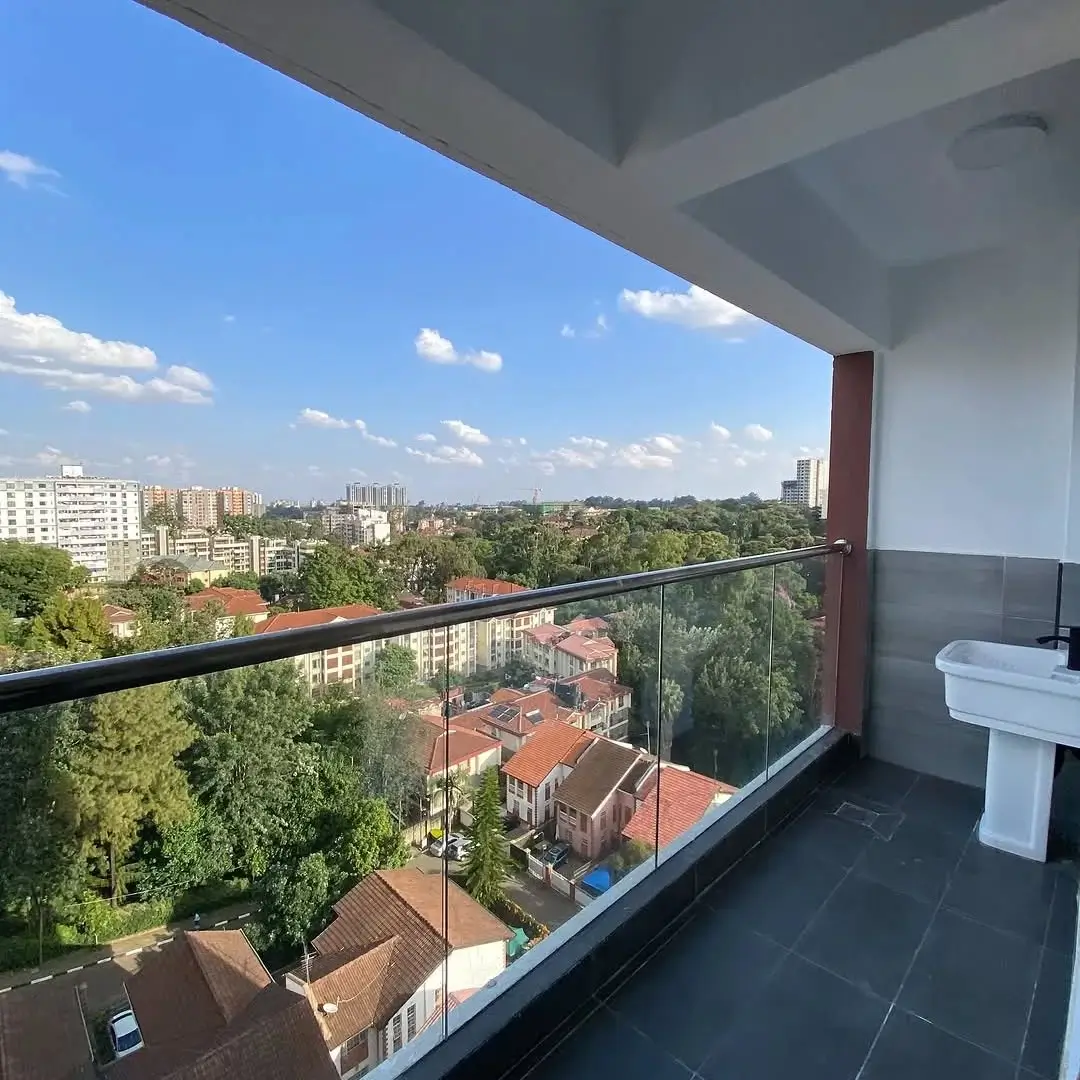 High-rise balcony with panoramic city and tree-lined views