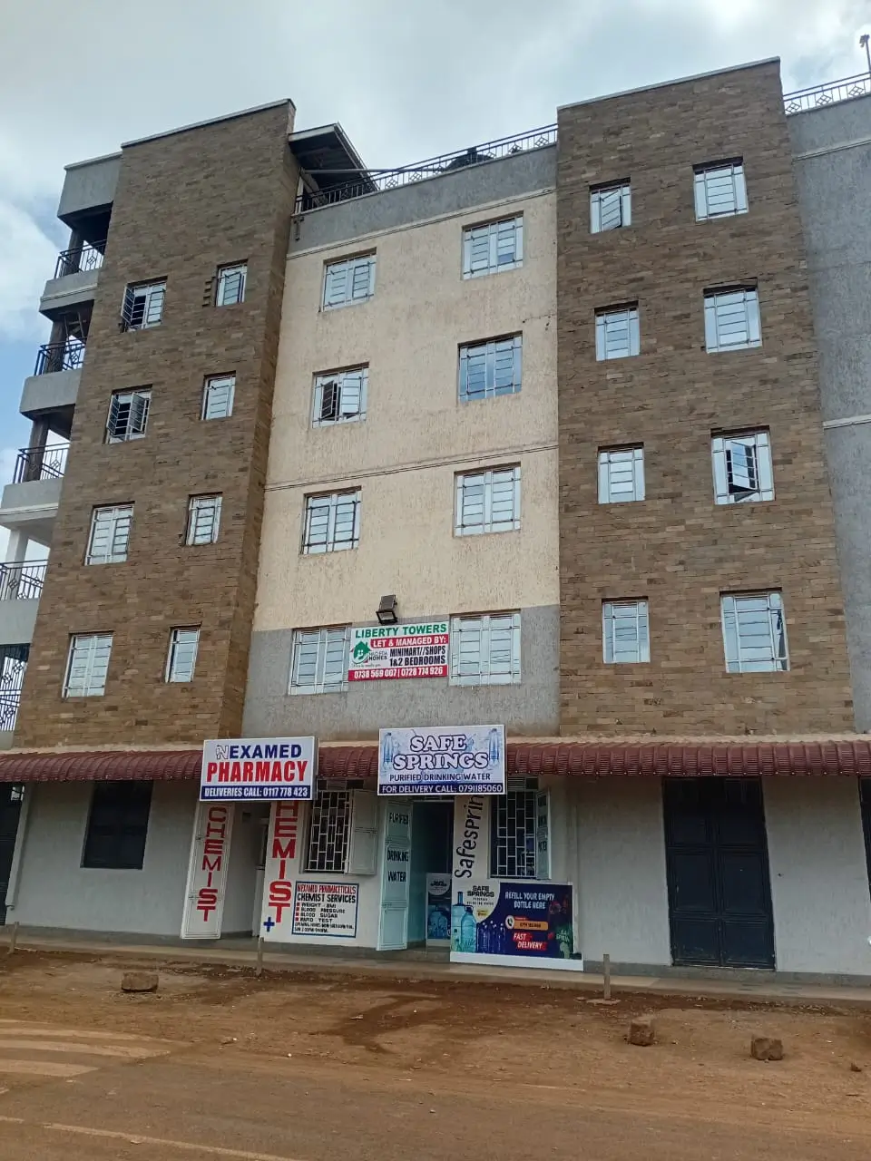 Multi-story residential building with ground-floor commercial shops