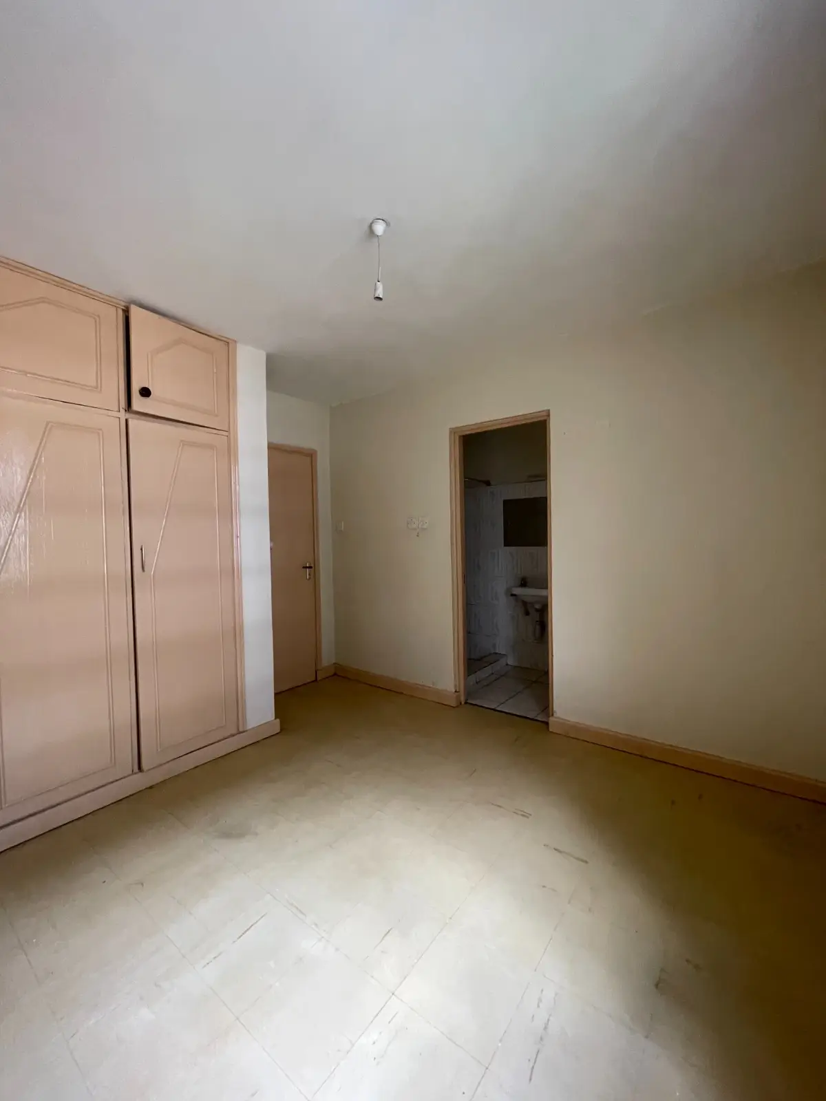 Empty bedroom with built-in wardrobe and en-suite entrance