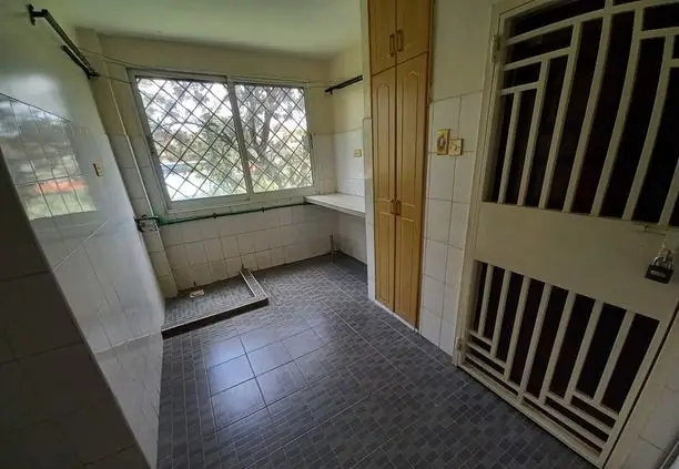 Compact kitchen with refrigerator, window, and tiled flooring