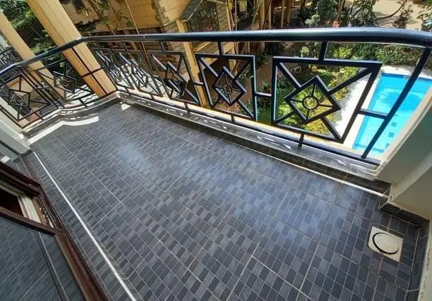 Spacious balcony with geometric railing and city views