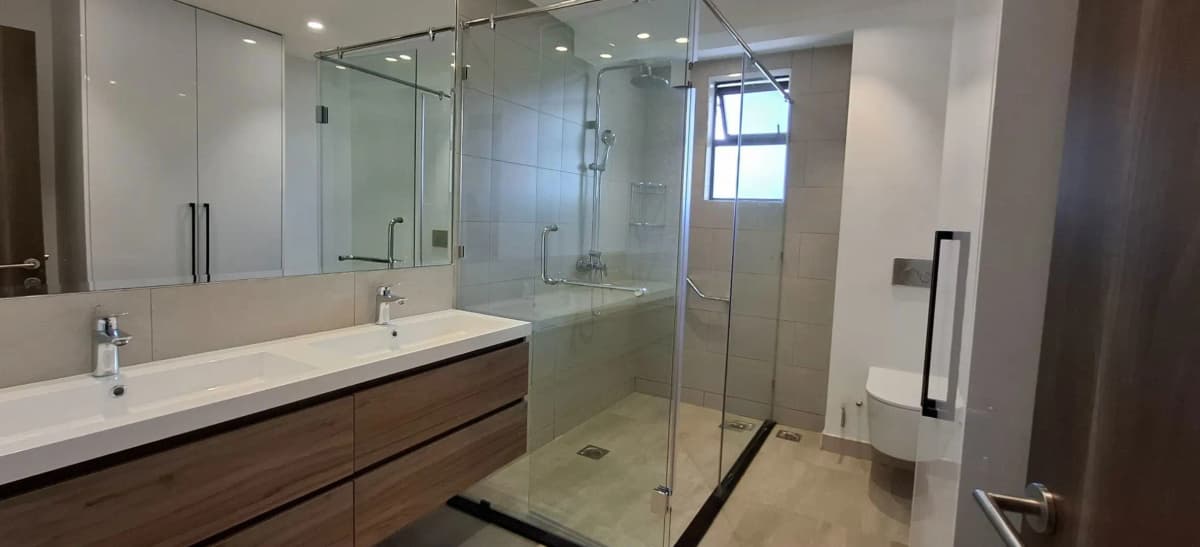 Modern bathroom with double vanity and walk-in shower enclosure