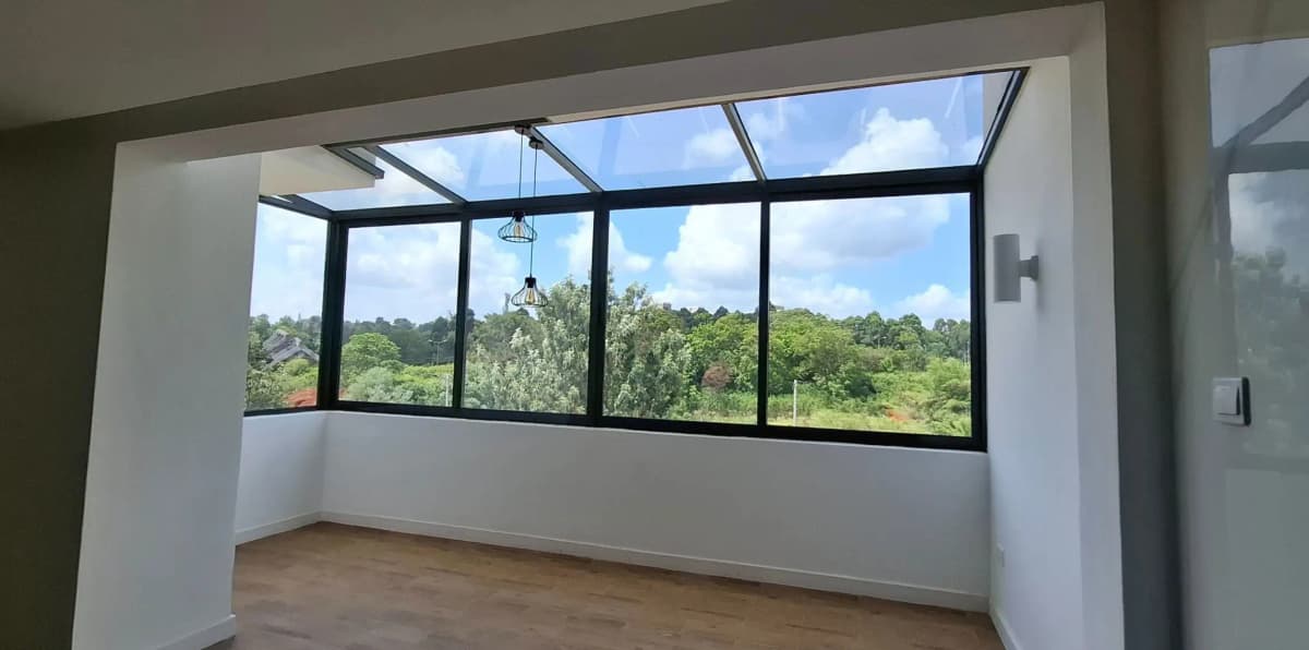 Enclosed glass balcony with panoramic garden views