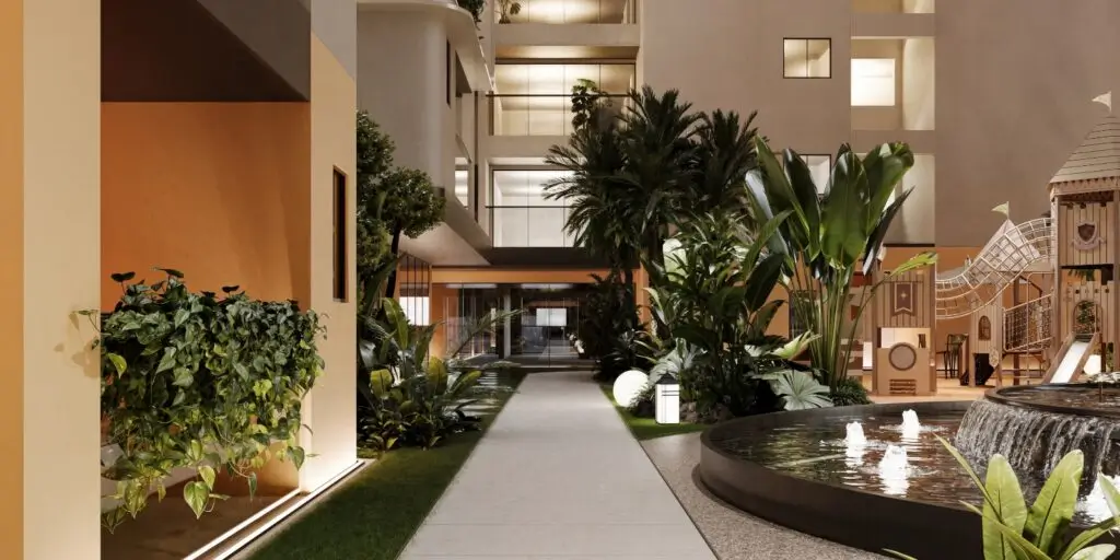 Landscaped indoor courtyard with fountain, palms, and playground