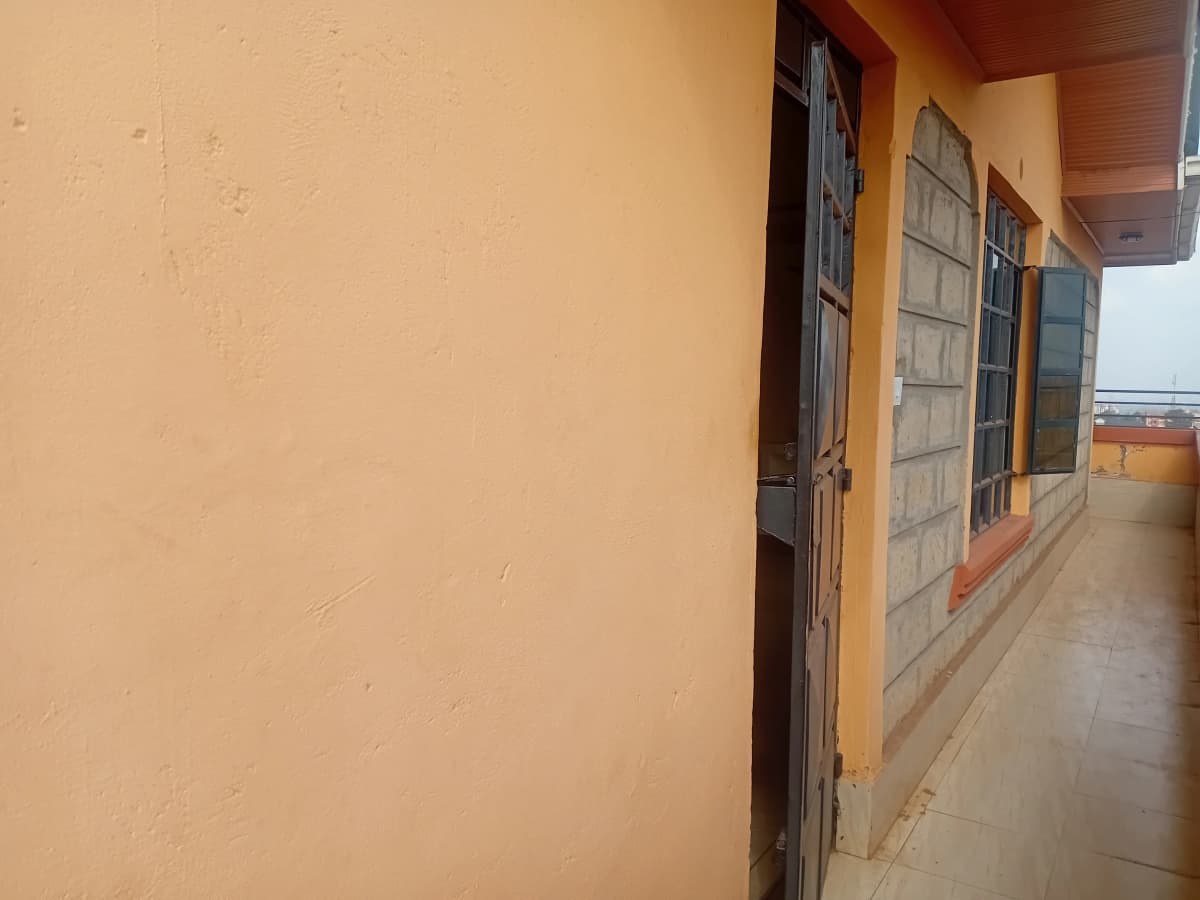 Corridor with yellow walls and multiple doors