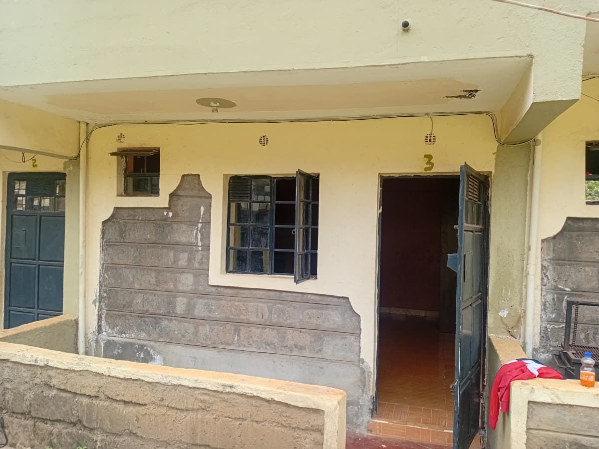 Building facade with numbered units and shared veranda entrance