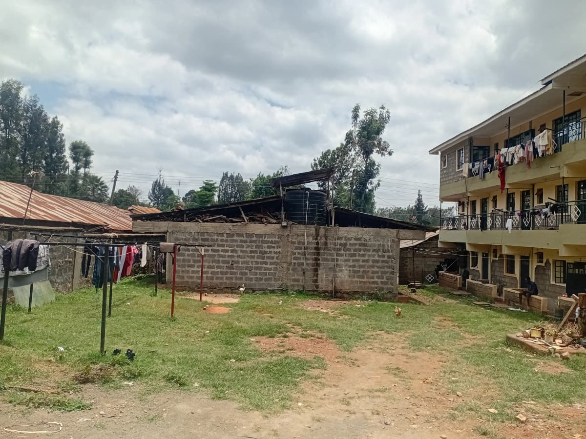 Compound grounds with clothesline and adjacent residential building