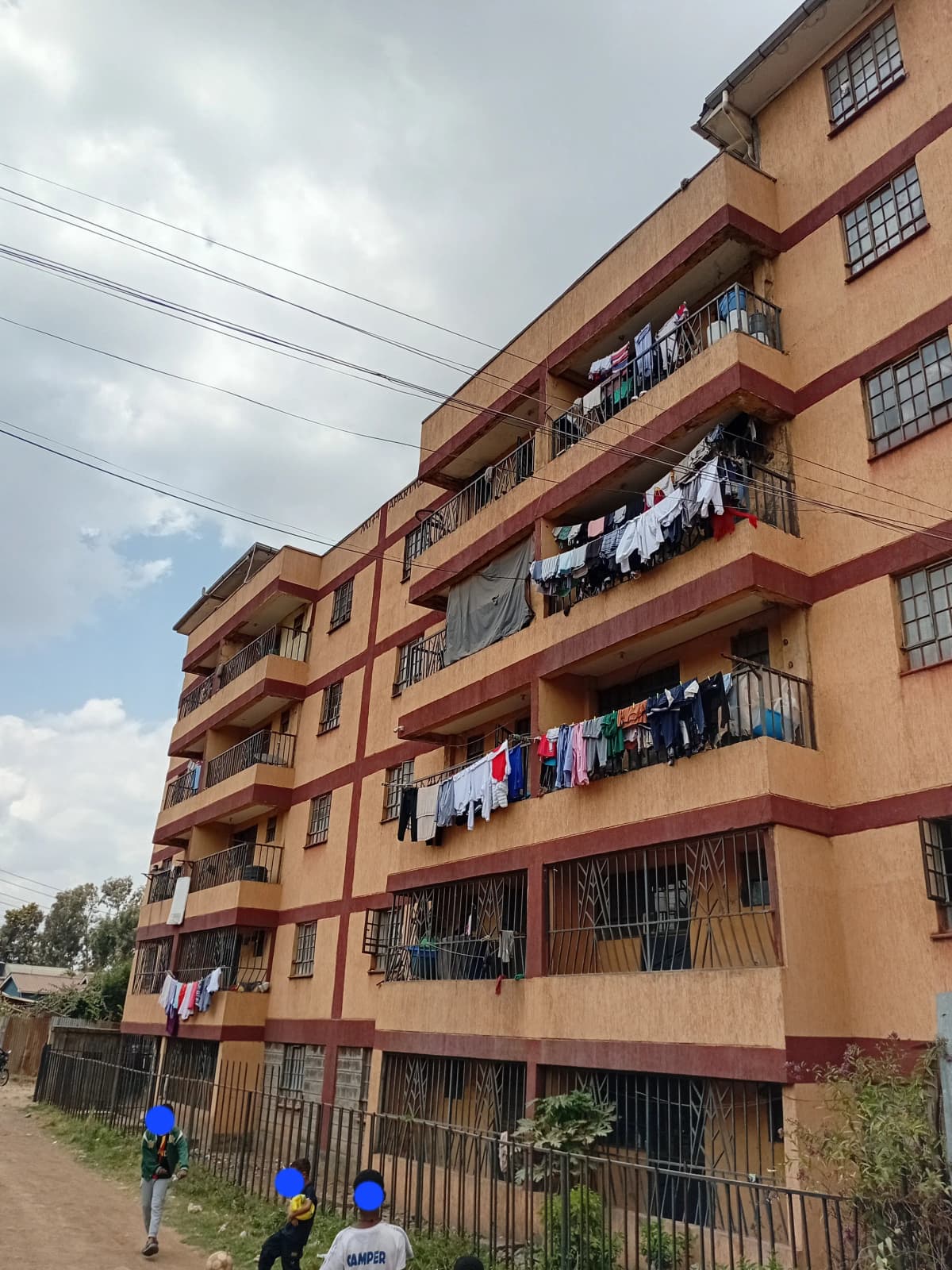 Multi-story residential building facade with balconies and laundry