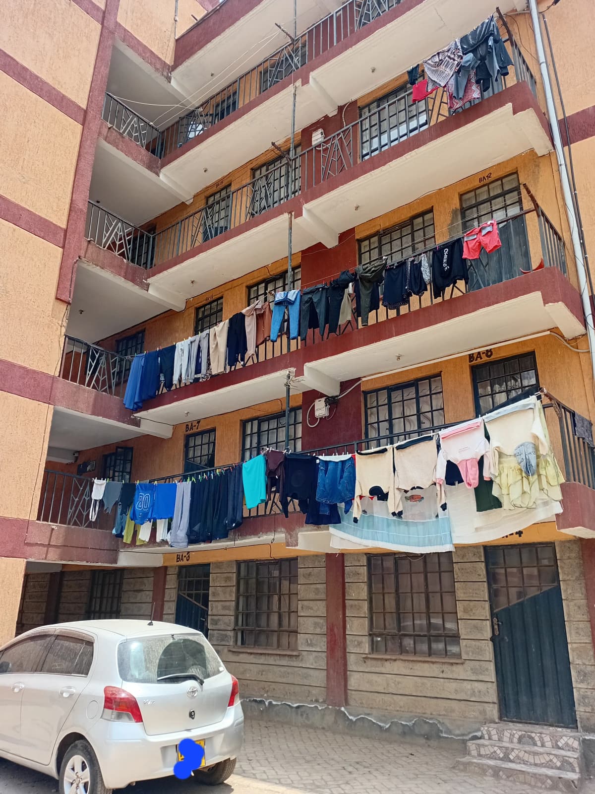 Multi-story residential building facade with laundry lines