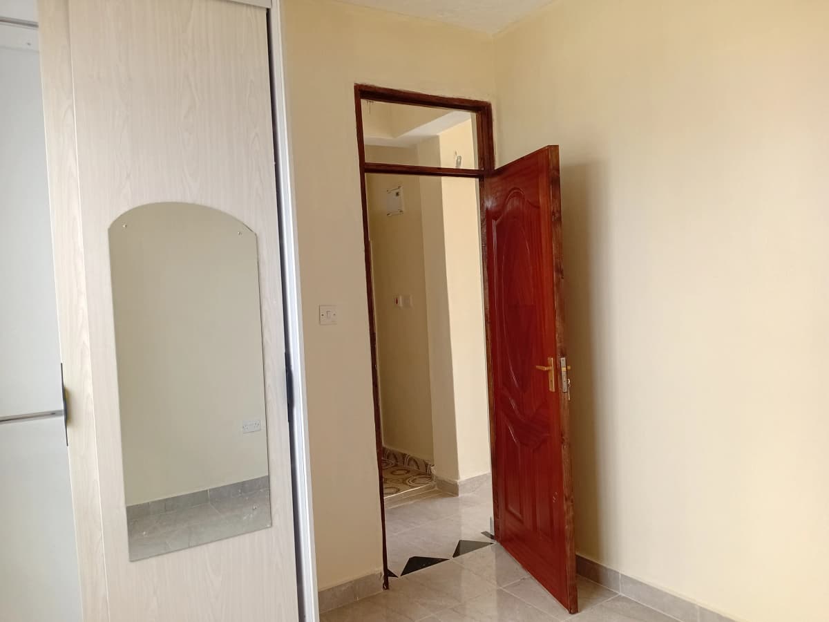 Building corridor with cream walls and red entrance door
