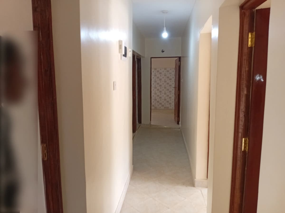 Internal hallway with wooden doors and neutral walls
