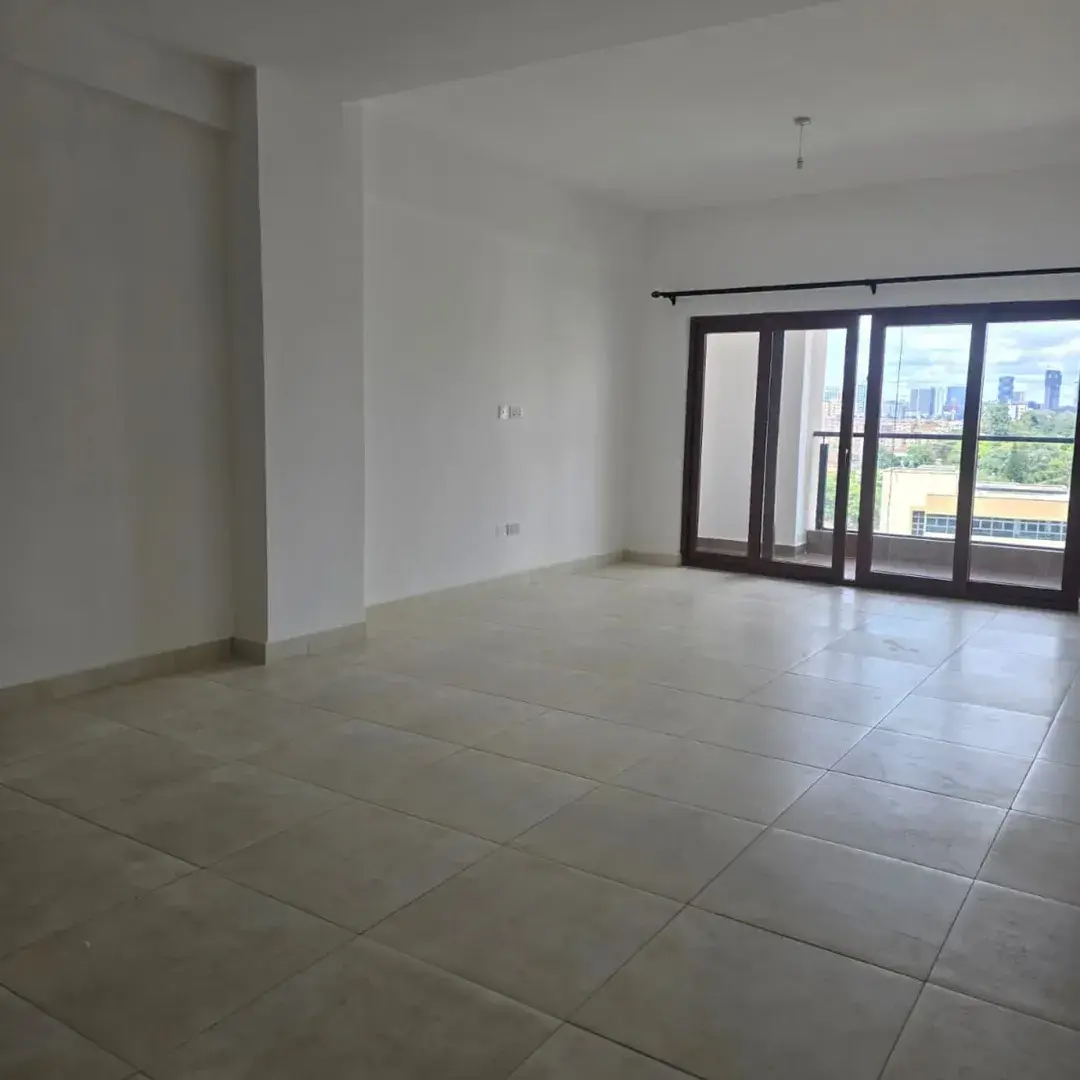 Spacious living room with floor-to-ceiling windows overlooking city