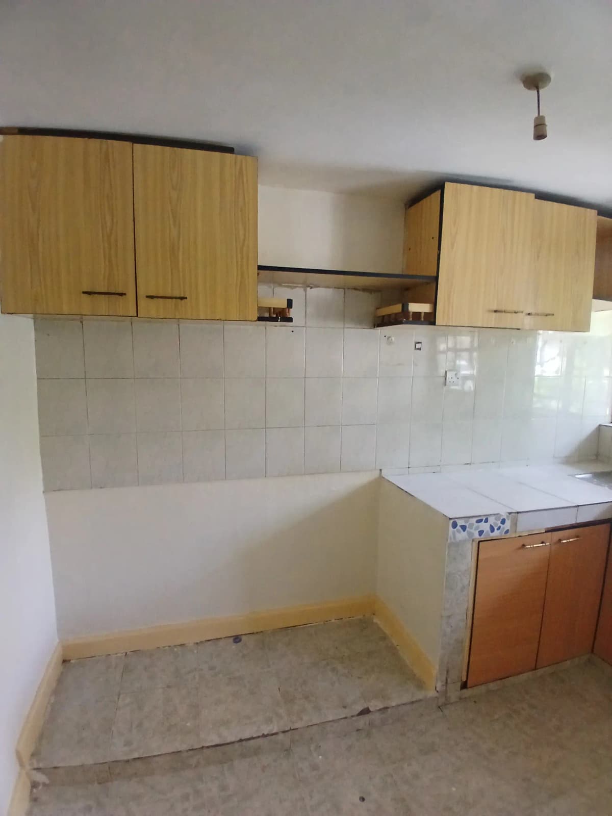 Basic kitchen with wooden cabinets and white tile backsplash