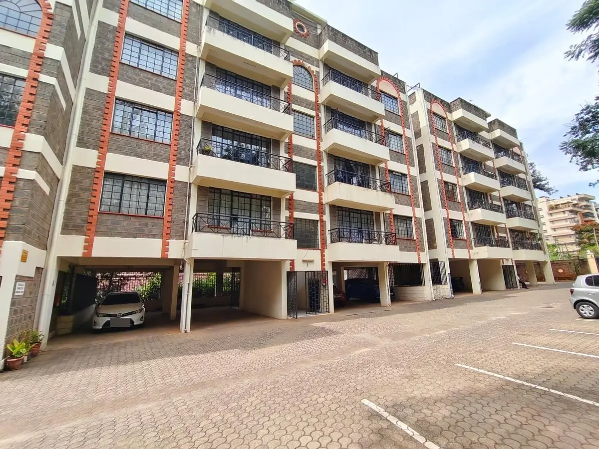 Multi-story residential building with ground-level parking bays