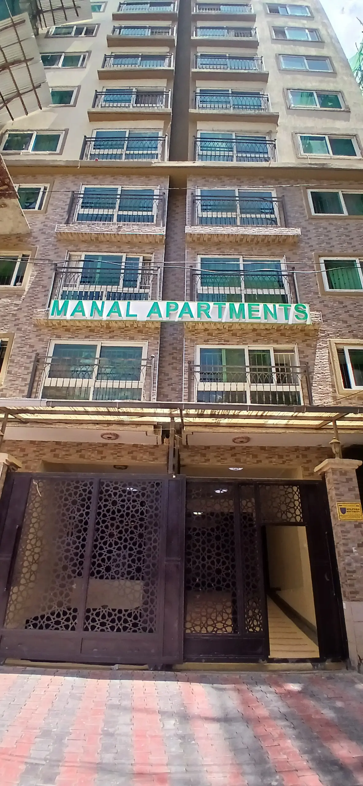 Multi-story residential building facade with balconies and entrance
