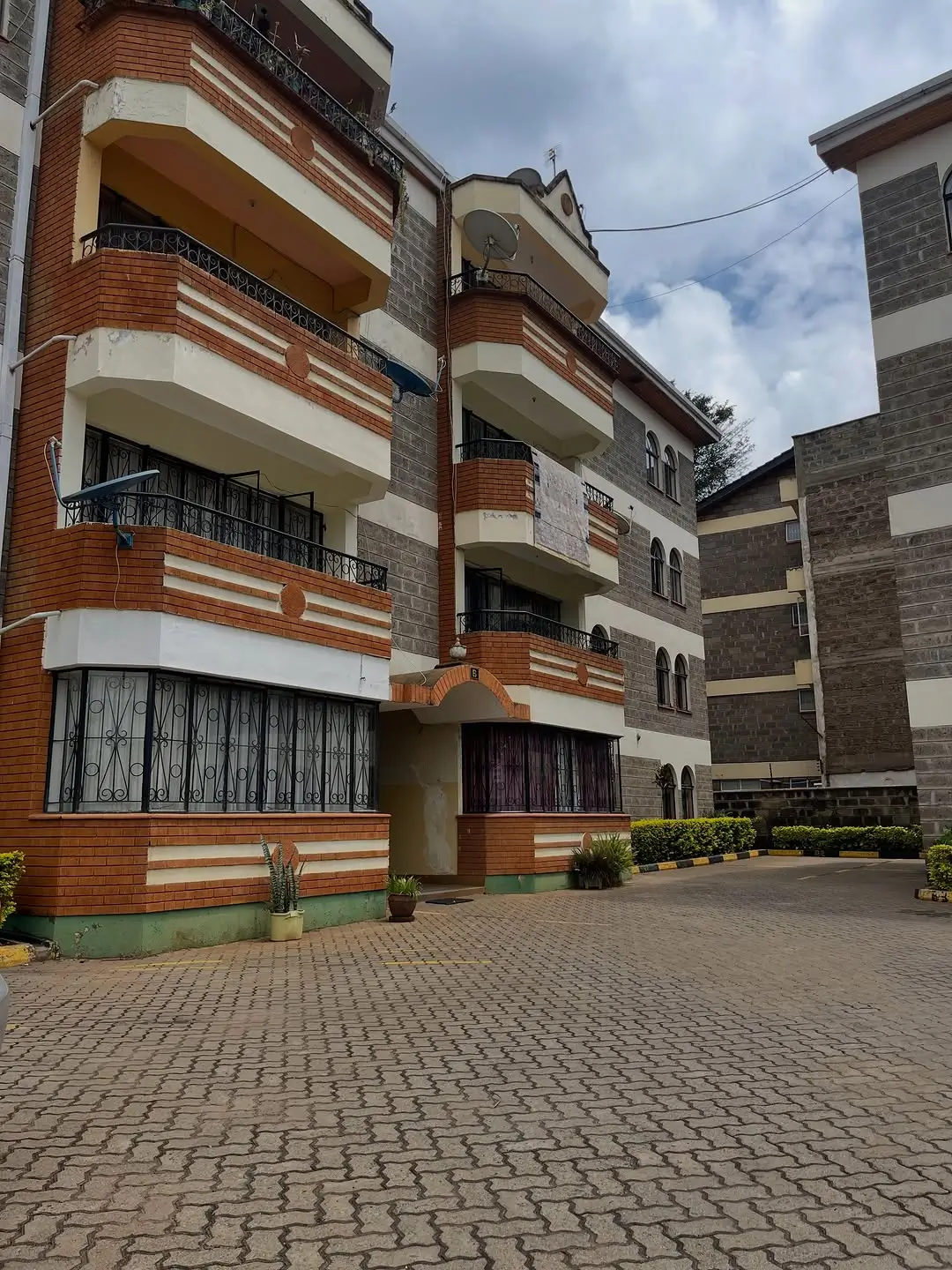 Multi-story residential building with brick facade and balconies