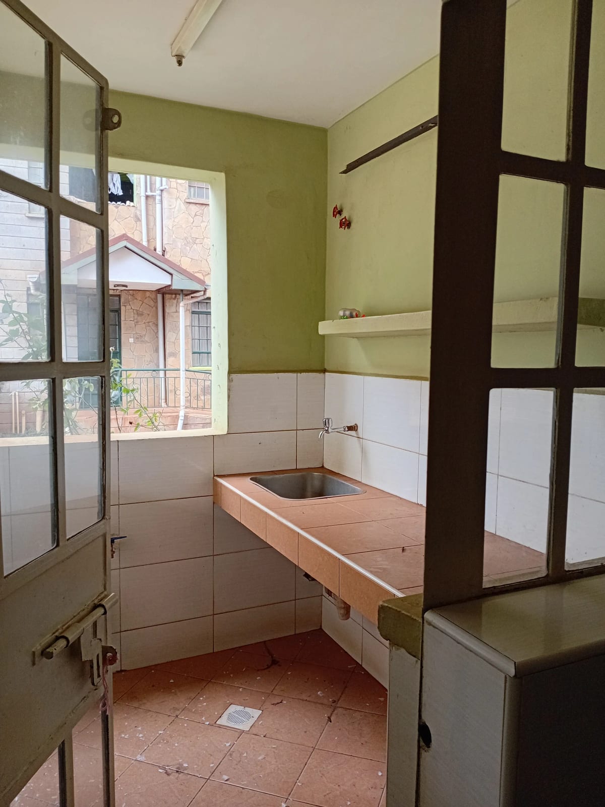 Bathroom with olive walls, white tiles, wooden sink vanity