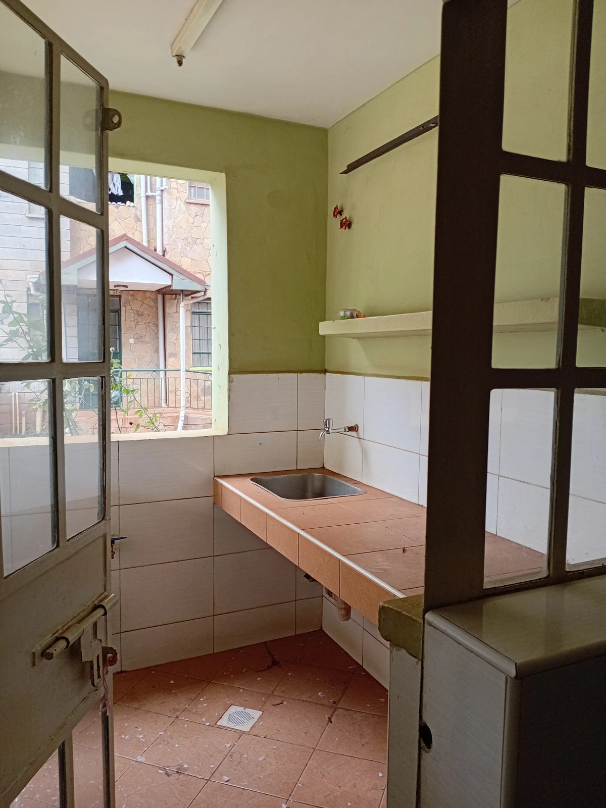 Bathroom with olive walls, white tiles, wooden sink vanity
