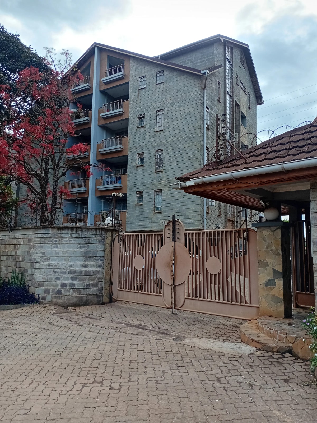 Multi-story residential building with metal gate entrance