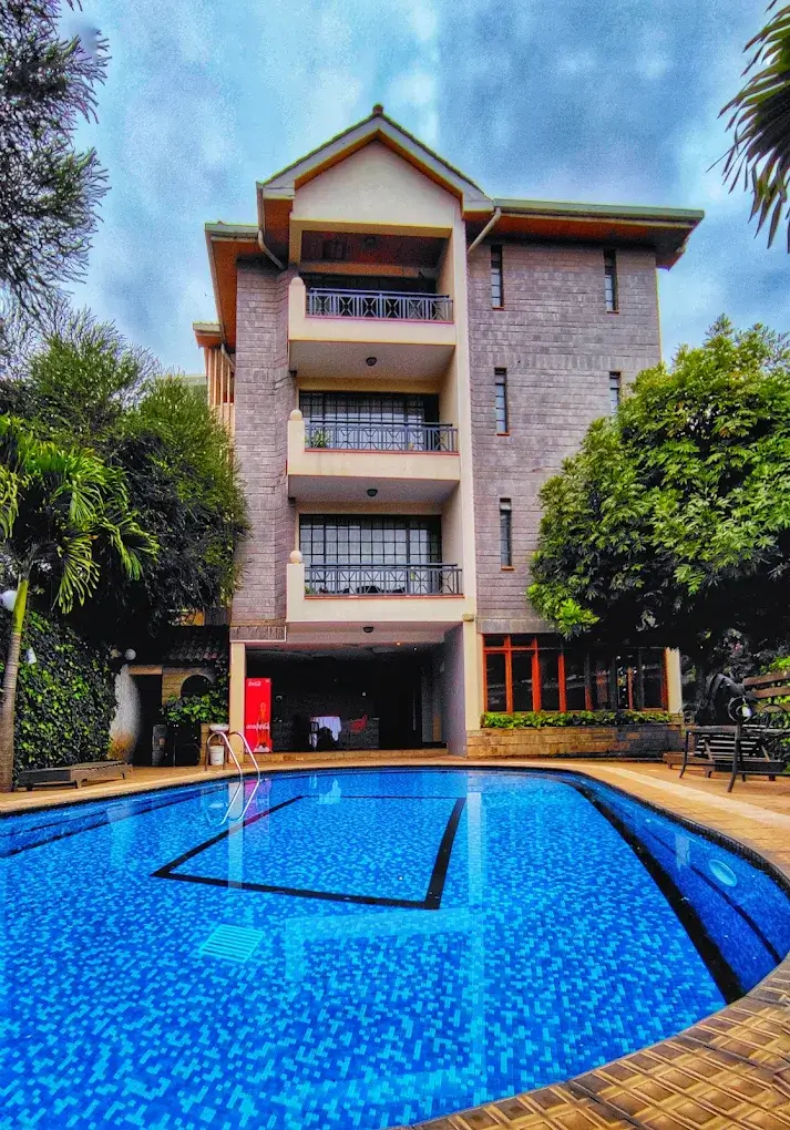 Rectangular swimming pool with brick multi-story building backdrop