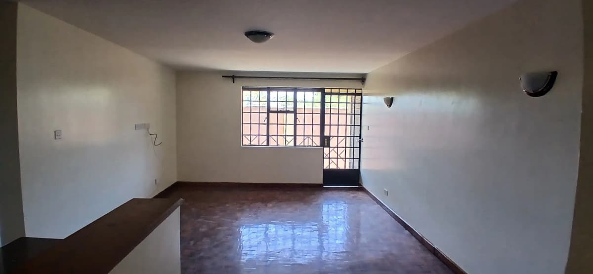 Spacious living room with polished concrete floor and barred windows