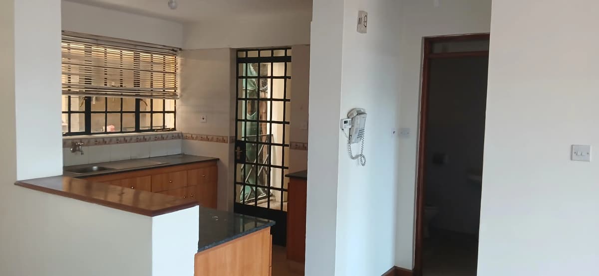 Open-plan kitchen with wooden counter and dining pass-through