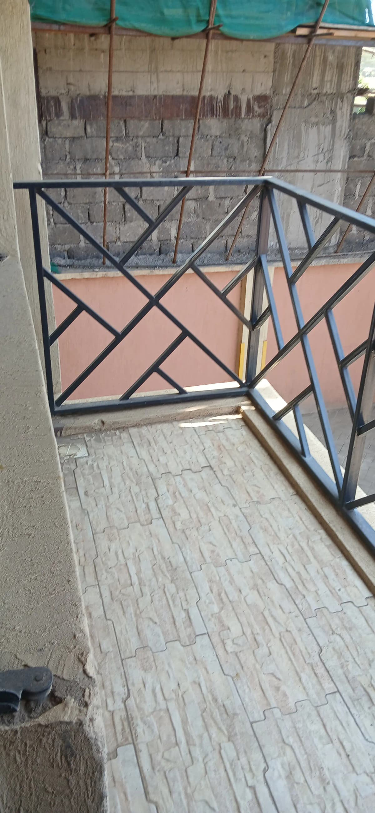 Balcony with metal railing and terracotta tile flooring